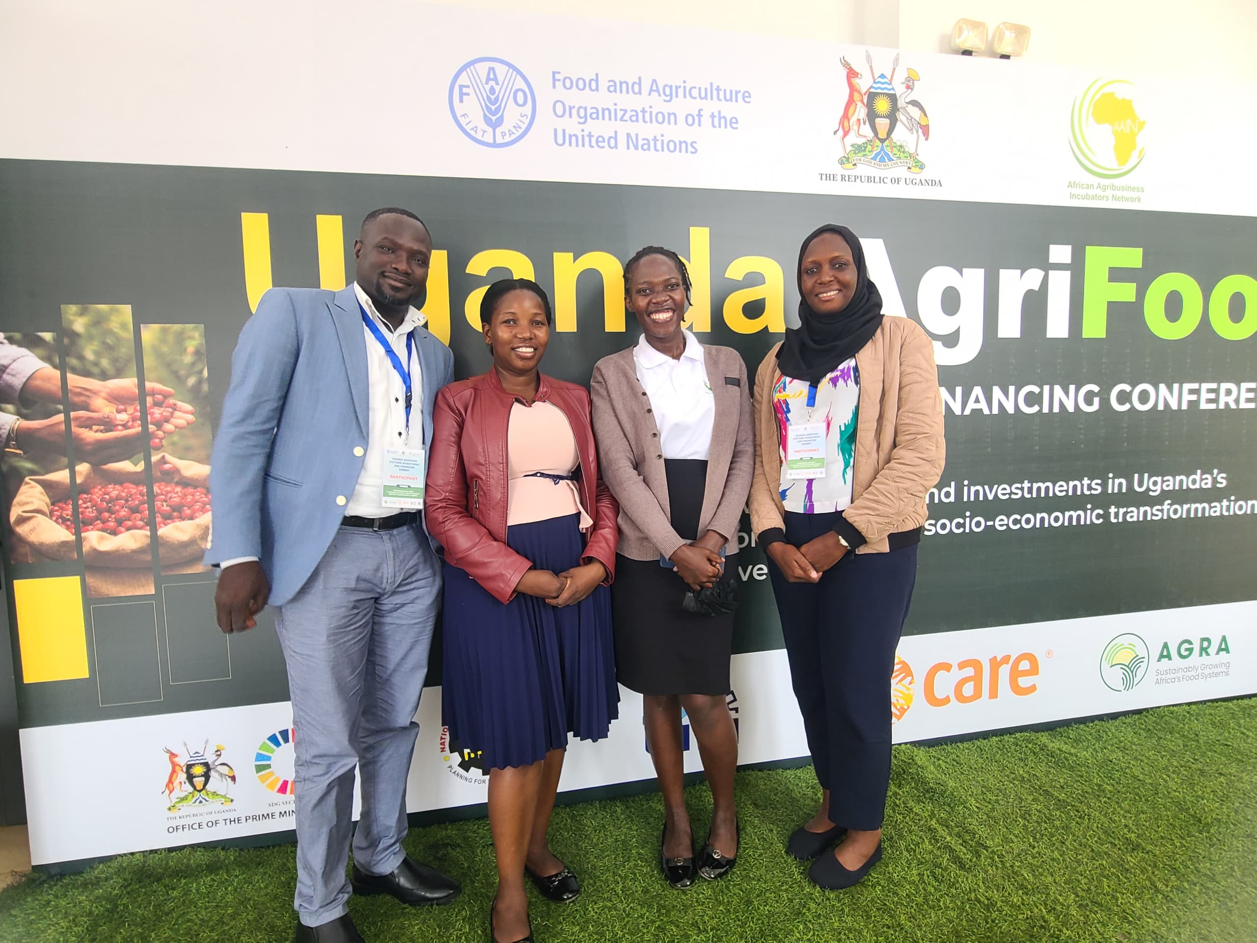 From left to right: Mr. Kizito Elvis (UPA-FNS), Ms. Doreen Akwera (Cefroht), Ms. Nyapendi Janet (KeBERA Organics), and Ms. Ashah Ntabadde (CONSENT) pose for a photo at the Uganda AgriFood Systems Investment and Financing Summit.